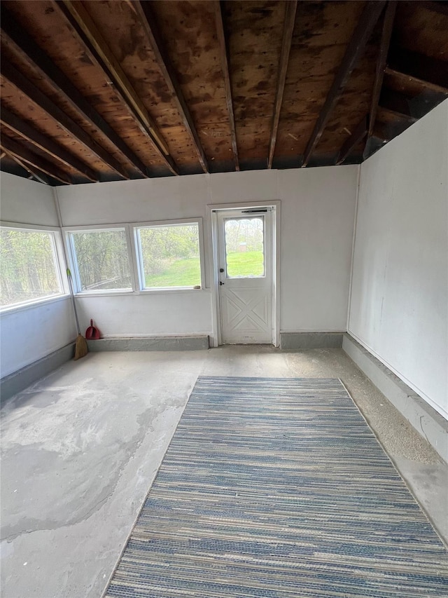 unfurnished sunroom with beamed ceiling