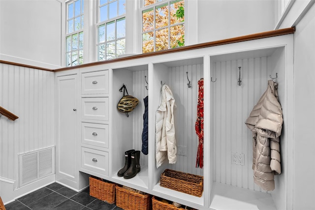 mudroom featuring visible vents and dark tile patterned floors