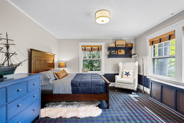 bedroom with crown molding, multiple windows, radiator heating unit, and carpet