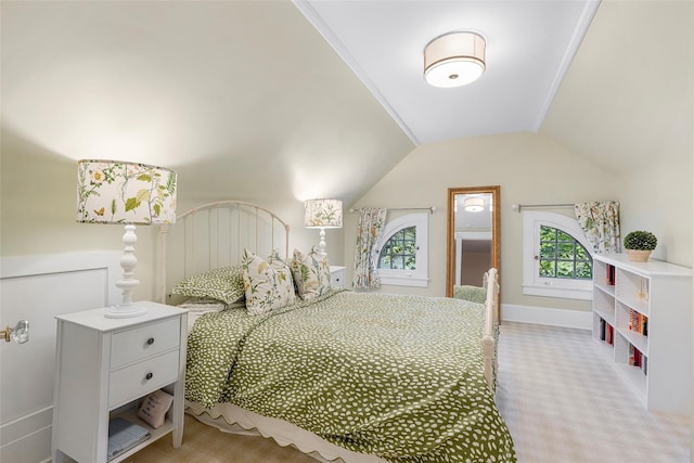 bedroom featuring multiple windows, light carpet, and lofted ceiling