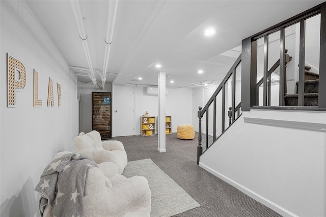finished below grade area with carpet flooring, recessed lighting, a wall unit AC, and stairway