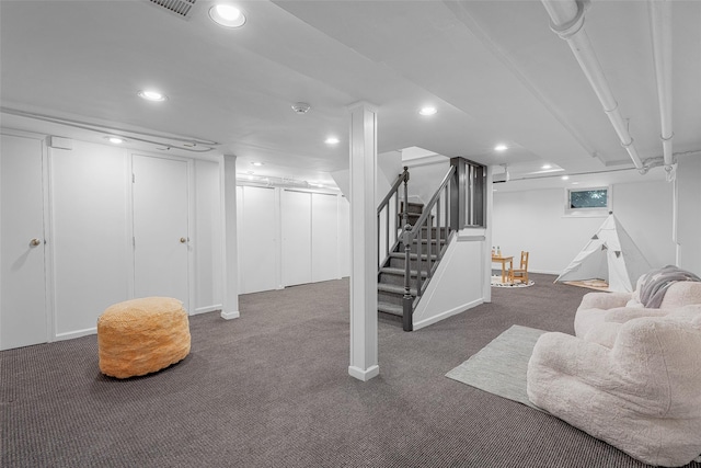 finished basement featuring stairs, carpet flooring, baseboards, and recessed lighting
