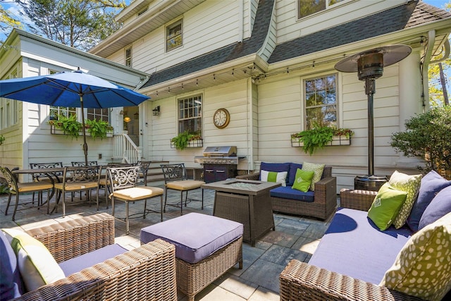view of patio with a grill, outdoor dining space, and an outdoor living space with a fire pit