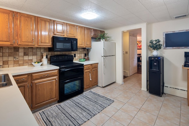 15 Riverview Farm Rd, Ossining, NY 10562 - kitchen with black appliances, light countertops, tasteful backsplash, and a baseboard radiator