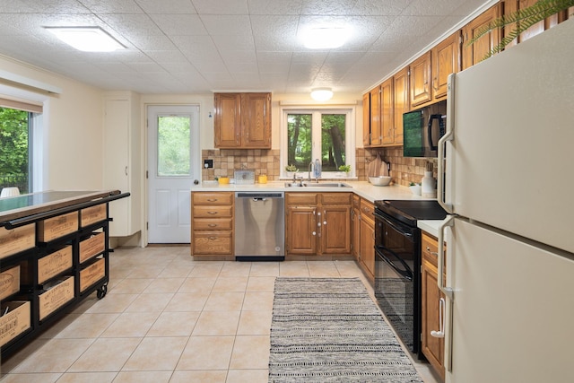 15 Riverview Farm Rd, Ossining, NY 10562 - kitchen with black appliances, a sink, light countertops, and tasteful backsplash