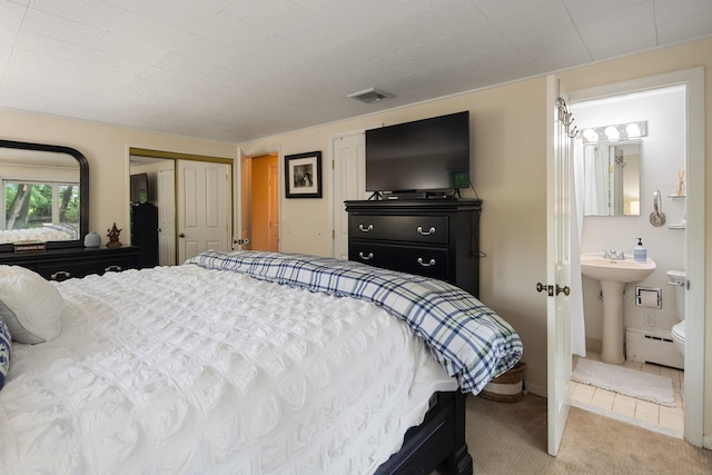 15 Riverview Farm Rd, Ossining, NY 10562 - carpeted bedroom with baseboard heating and ensuite bath
