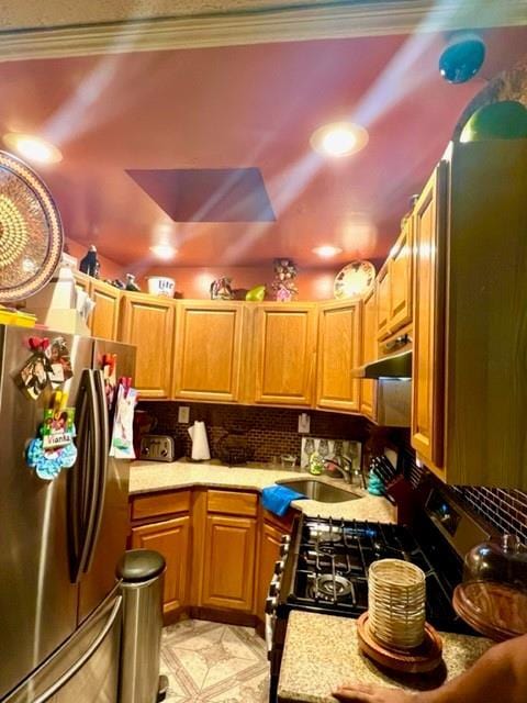 3231 Grace Ave, Bronx, NY 10469 - kitchen with a sink, light countertops, stainless steel appliances, backsplash, and under cabinet range hood