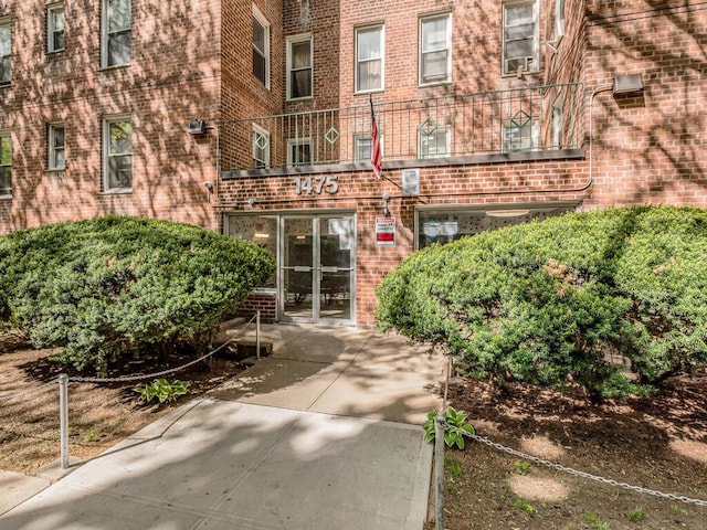 1475 Thieriot Ave Unit 5N, Bronx, NY 10460 - view of exterior entry featuring brick siding and a balcony