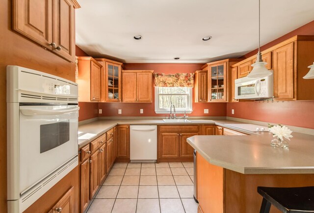 163 Smith Rd, Poughkeepsie, NY 12603 - kitchen with a peninsula, white appliances, light countertops, a sink, and decorative light fixtures