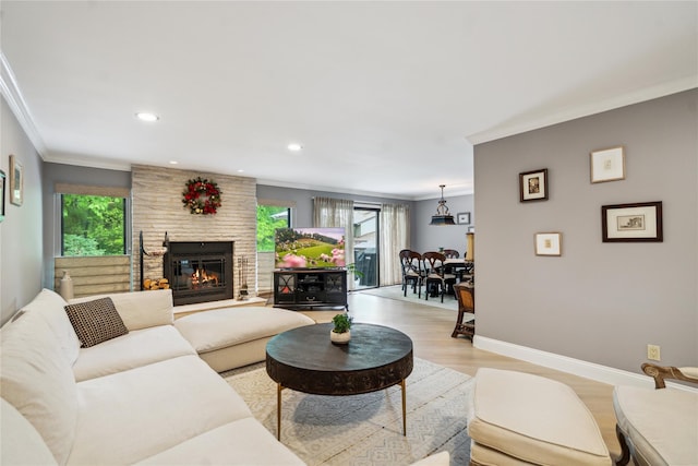 185 Old Pond Ct Unit 185, Jericho, NY 11753 - living area with ornamental molding, a stone fireplace, light wood-style flooring, baseboards, and recessed lighting