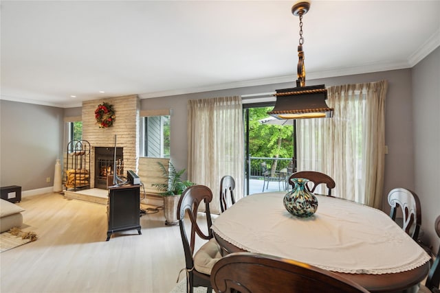 185 Old Pond Ct Unit 185, Jericho, NY 11753 - dining area featuring light wood-style flooring, ornamental molding, baseboards, a brick fireplace, and recessed lighting