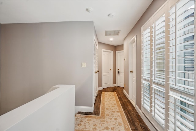 185 Old Pond Ct Unit 185, Jericho, NY 11753 - hall with dark wood-style flooring, baseboards, and an upstairs landing