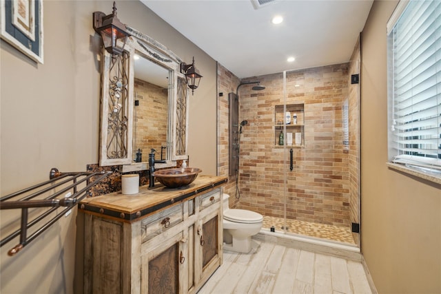 185 Old Pond Ct Unit 185, Jericho, NY 11753 - full bathroom with a shower stall, recessed lighting, toilet, vanity, and wood finished floors