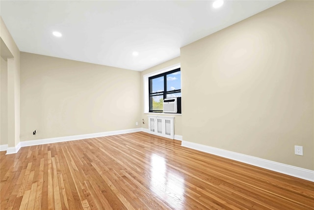 25-40 Union St Unit 6B, Flushing, NY 11354 - empty room featuring light wood-type flooring, recessed lighting, baseboards, and cooling unit