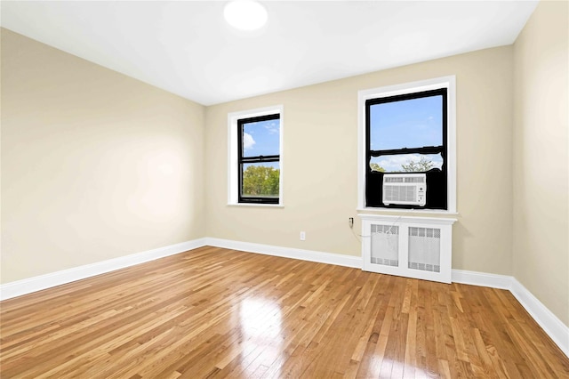 25-40 Union St Unit 6B, Flushing, NY 11354 - unfurnished room featuring baseboards, radiator heating unit, light wood finished floors, and cooling unit