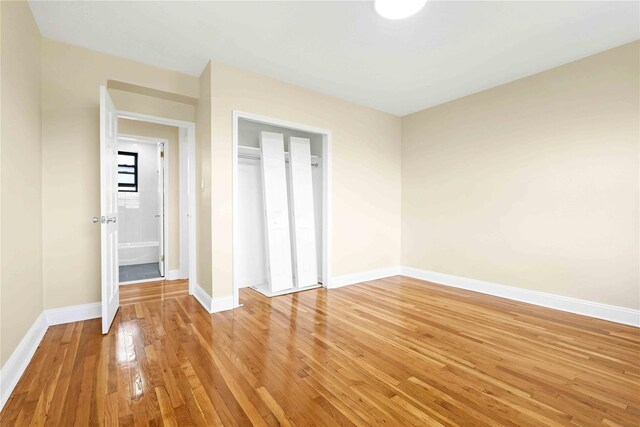 25-40 Union St Unit 6B, Flushing, NY 11354 - unfurnished bedroom with a closet, baseboards, and light wood-style floors