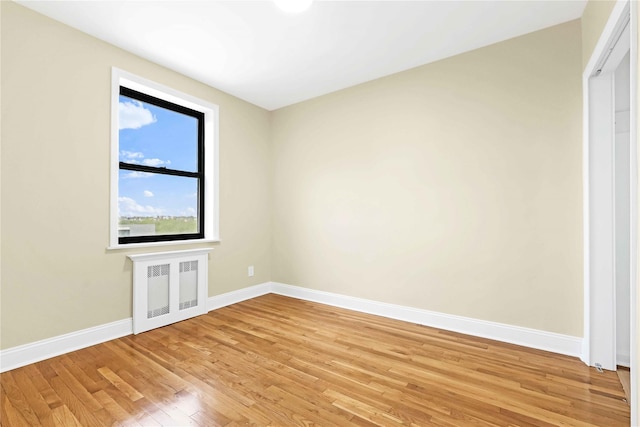 25-40 Union St Unit 6B, Flushing, NY 11354 - unfurnished room featuring baseboards, light wood-style flooring, and radiator