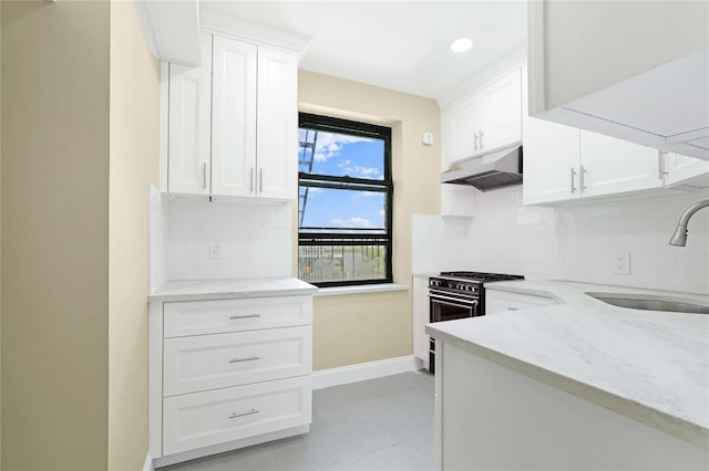25-40 Union St Unit 6B, Flushing, NY 11354 - kitchen with decorative backsplash, gas range oven, under cabinet range hood, white cabinets, and a sink