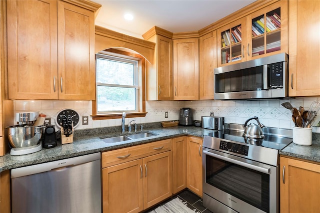 16 Charlotte Dr, Lagrangeville, NY 12540 - kitchen featuring appliances with stainless steel finishes, a sink, glass insert cabinets, decorative backsplash, and dark stone countertops
