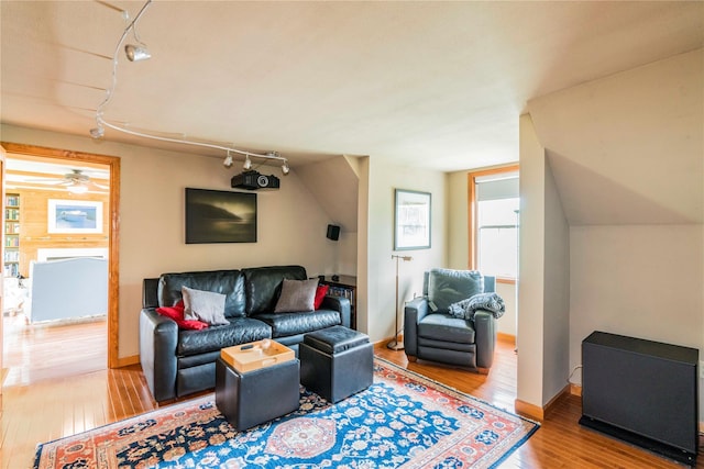 16 Charlotte Dr, Lagrangeville, NY 12540 - living room with track lighting, hardwood / wood-style floors, baseboards, and plenty of natural light