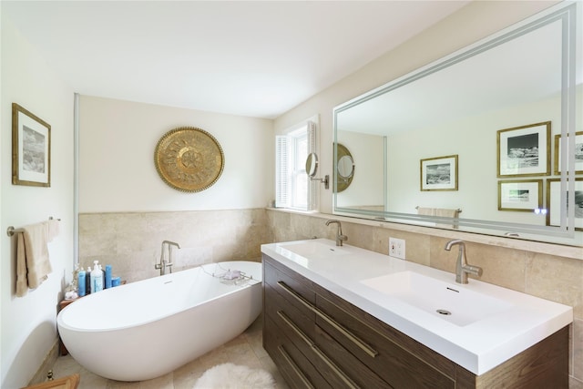 16 Charlotte Dr, Lagrangeville, NY 12540 - full bath with tile walls, a freestanding tub, double vanity, tile patterned floors, and a wainscoted wall