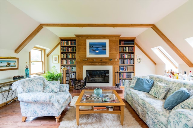 16 Charlotte Dr, Lagrangeville, NY 12540 - living room featuring a skylight, wood finished floors, a fireplace, and built in shelves