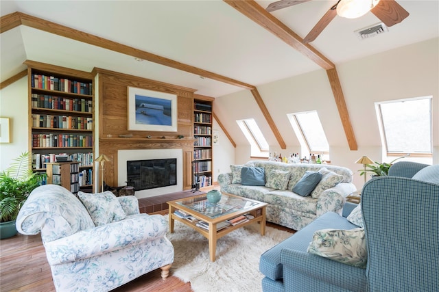 16 Charlotte Dr, Lagrangeville, NY 12540 - living room with wood finished floors, a ceiling fan, beamed ceiling, and a fireplace