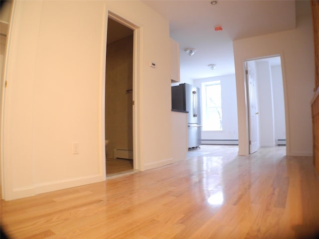 237 Madison St, Brooklyn, NY 11216 - unfurnished room with a baseboard radiator, light wood finished floors, and baseboards