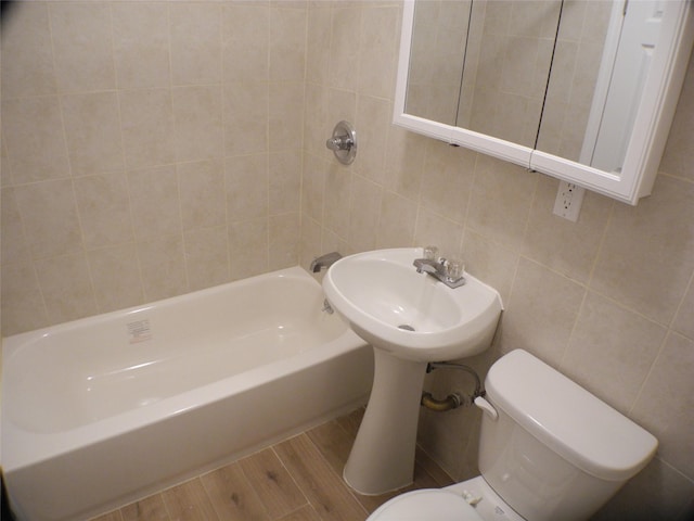 237 Madison St, Brooklyn, NY 11216 - full bath featuring tile walls, toilet, wood finished floors, and shower / bath combination