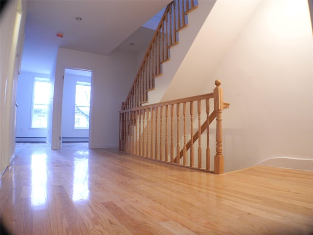 237 Madison St, Brooklyn, NY 11216 - staircase featuring wood finished floors and a baseboard radiator