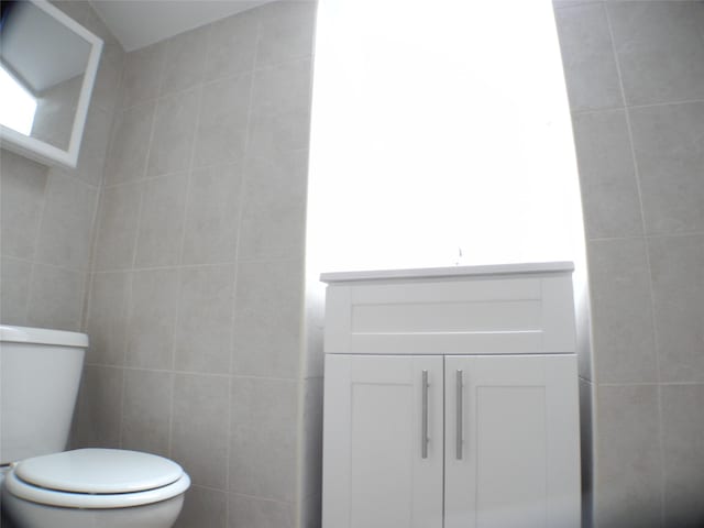 237 Madison St, Brooklyn, NY 11216 - half bathroom with tile walls, toilet, and vanity