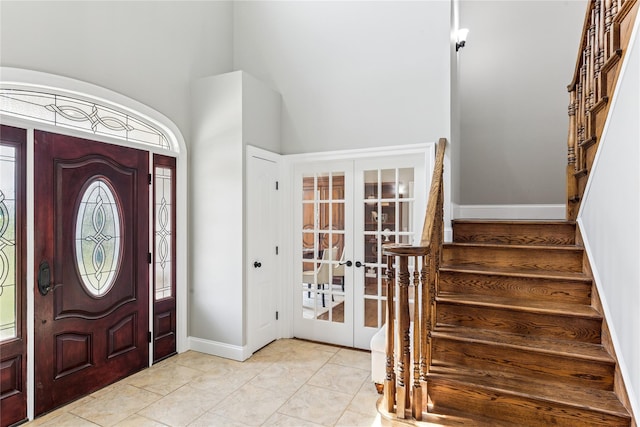 1465 Ackerly Pond Ln, Southold, NY 11971 - entryway featuring french doors, stairs, and high vaulted ceiling