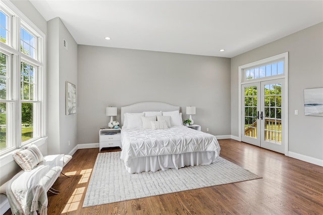 1465 Ackerly Pond Ln, Southold, NY 11971 - bedroom with multiple windows, access to outside, french doors, wood finished floors, and recessed lighting