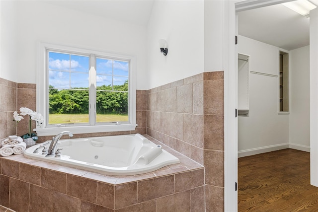 1465 Ackerly Pond Ln, Southold, NY 11971 - bathroom with a whirlpool tub, wood finished floors, and wainscoting