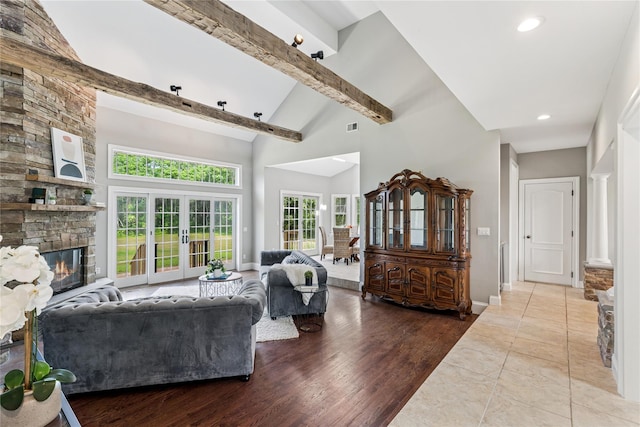 1465 Ackerly Pond Ln, Southold, NY 11971 - living area featuring high vaulted ceiling, a stone fireplace, french doors, beam ceiling, and recessed lighting