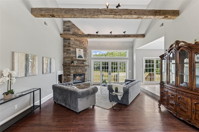 1465 Ackerly Pond Ln, Southold, NY 11971 - living room featuring a towering ceiling, beamed ceiling, a fireplace, and wood finished floors