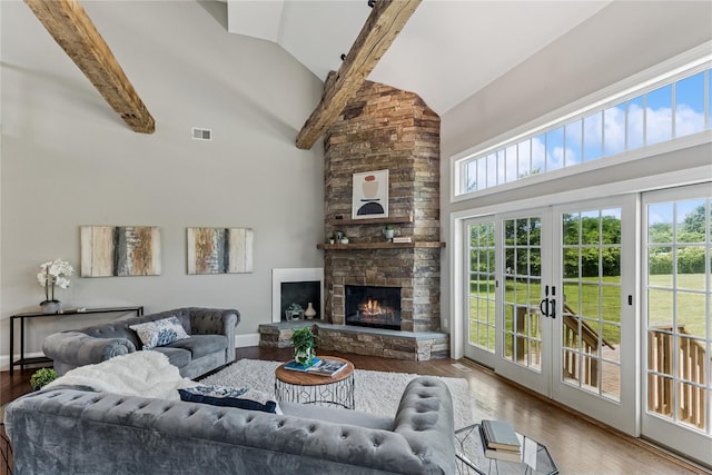 1465 Ackerly Pond Ln, Southold, NY 11971 - living area featuring high vaulted ceiling, wood finished floors, french doors, and a stone fireplace
