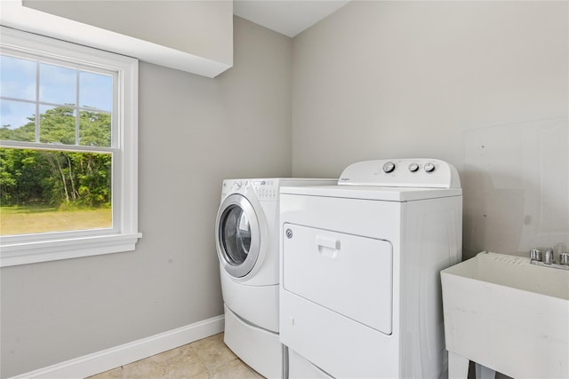 1465 Ackerly Pond Ln, Southold, NY 11971 - washroom with washing machine and dryer and light tile patterned floors