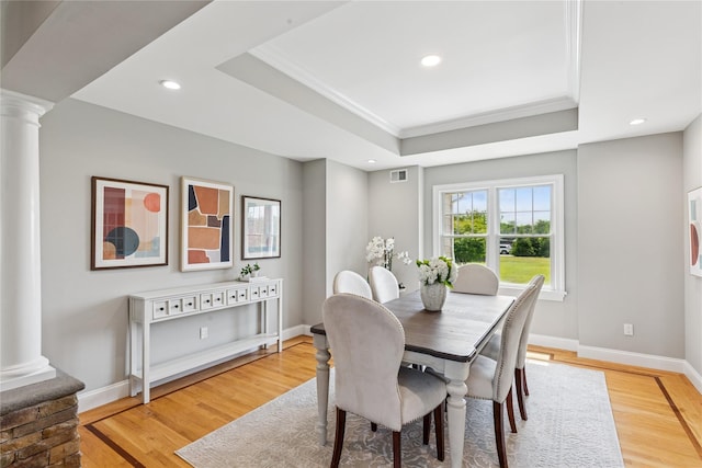 1465 Ackerly Pond Ln, Southold, NY 11971 - dining space featuring decorative columns, a tray ceiling, ornamental molding, light wood-type flooring, and recessed lighting