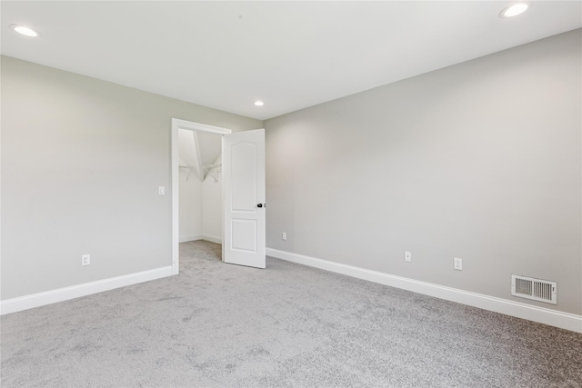 1465 Ackerly Pond Ln, Southold, NY 11971 - unfurnished bedroom with carpet flooring, recessed lighting, a spacious closet, and a closet