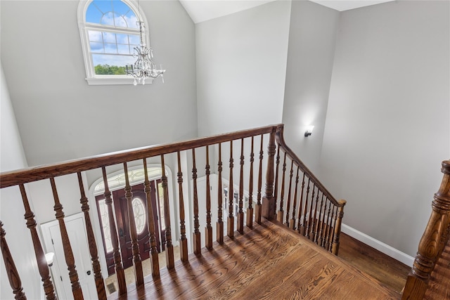 1465 Ackerly Pond Ln, Southold, NY 11971 - staircase featuring wood finished floors and a chandelier