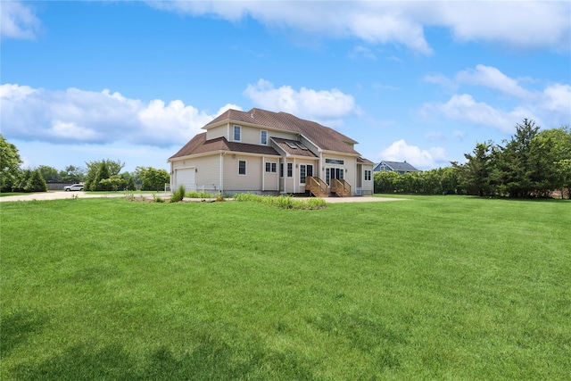1465 Ackerly Pond Ln, Southold, NY 11971 - rear view of property with a yard and an attached garage