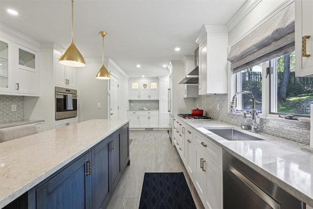 kitchen with a sink, appliances with stainless steel finishes, decorative backsplash, white cabinets, and glass insert cabinets
