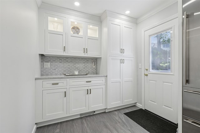 doorway to outside with baseboards, recessed lighting, and light wood finished floors