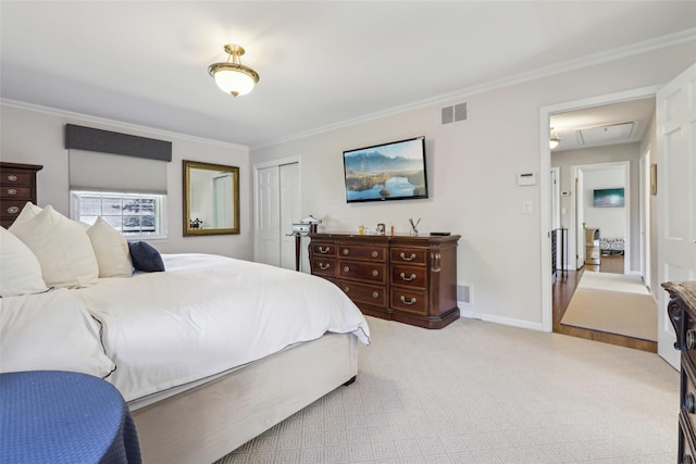 bedroom featuring attic access, light carpet, ornamental molding, a closet, and baseboards