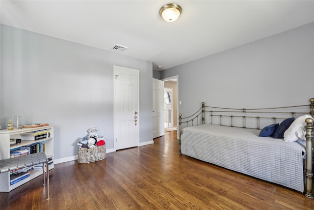 bedroom featuring wood finished floors and baseboards