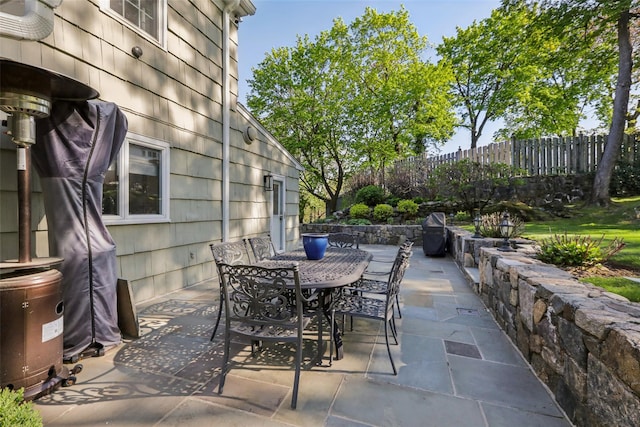 view of patio / terrace with outdoor dining space and fence