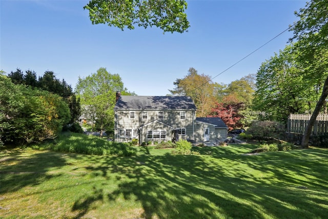 rear view of property with a lawn