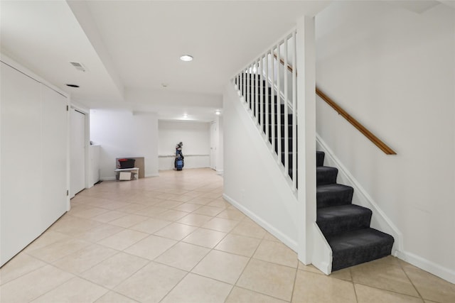 stairs featuring tile patterned flooring, recessed lighting, and baseboards