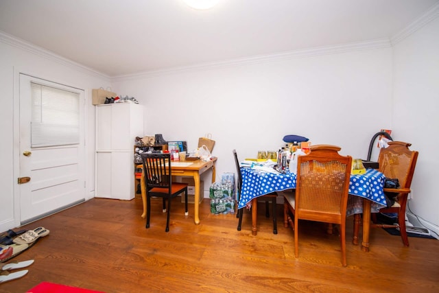 dining room featuring ornamental molding and wood finished floors